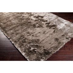 Shaggy beige rug on a dark hardwood floor
