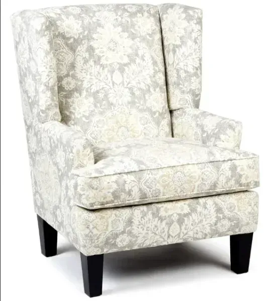 Cream upholstered wingback armchair with floral pattern and dark wooden legs