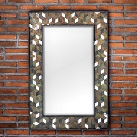 Decorative mosaic picture frame with a blank white center on a brick wall