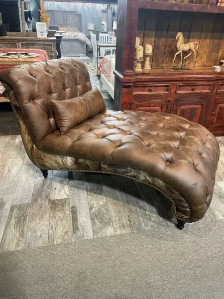 Brown tufted chaise lounge in a furniture store showroom