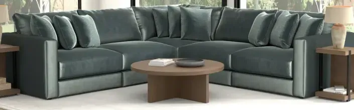 Gray L-shaped sectional sofa with coffee table and lamps in a modern living room