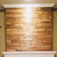 Wood-paneled wall niche with white trim and a bright light glare at the top center.