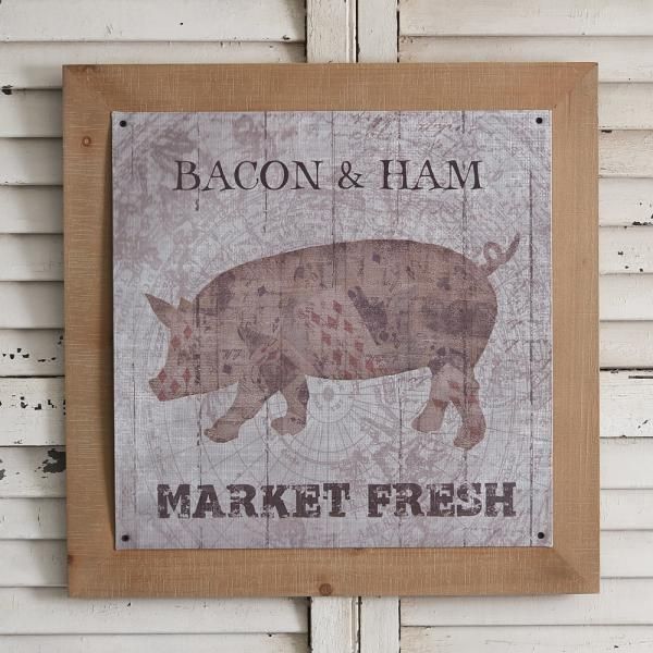 Rustic wall sign with a pig illustration and the words “BACON & HAM” and “MARKET FRESH”