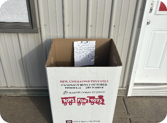 A cardboard box that says toys for tots on it