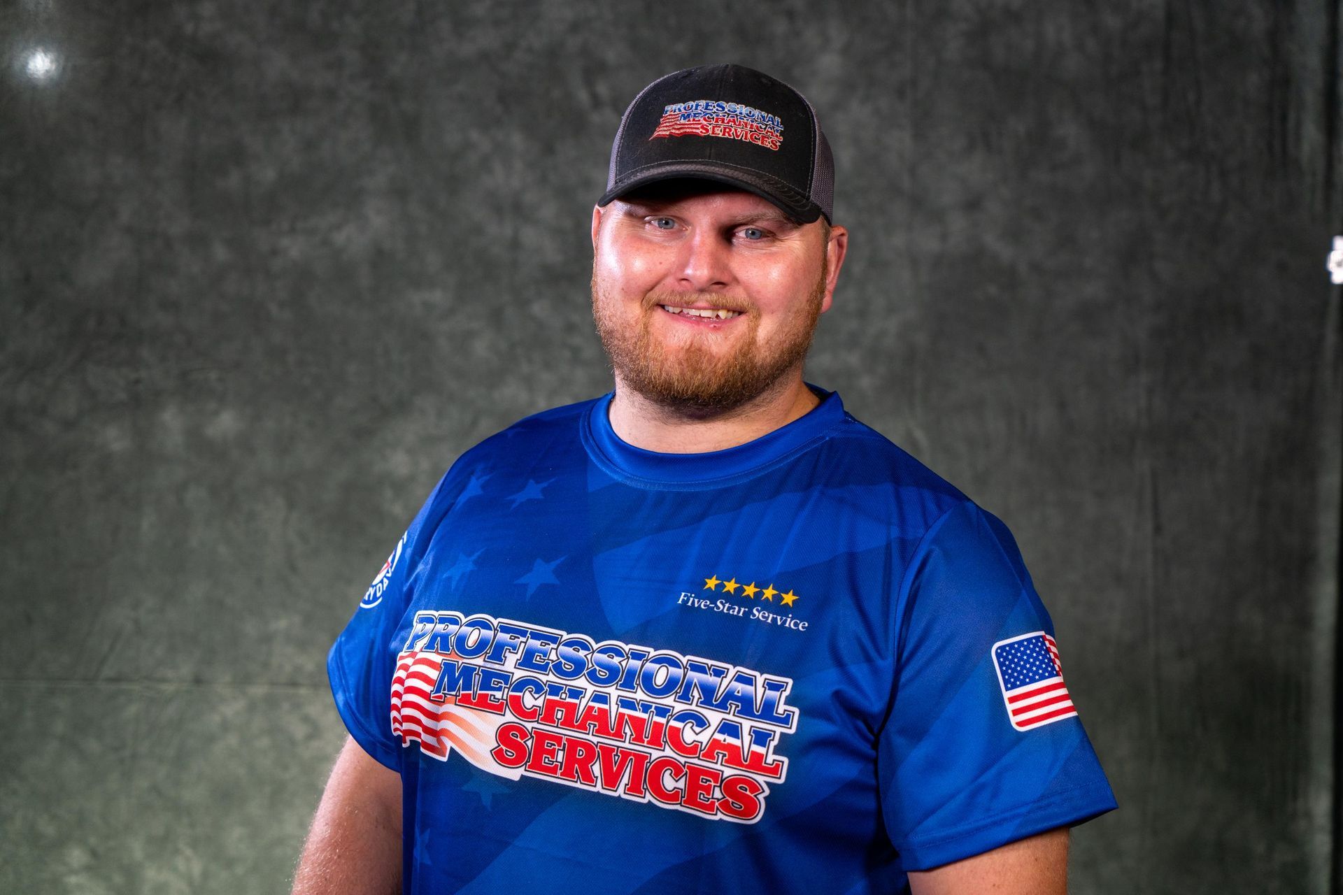 Man wearing a cap and blue shirt with 