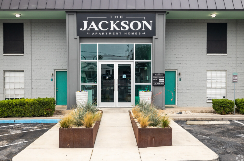 Jackson Laboratory entrance with glass doors, teal accents, and concrete planters