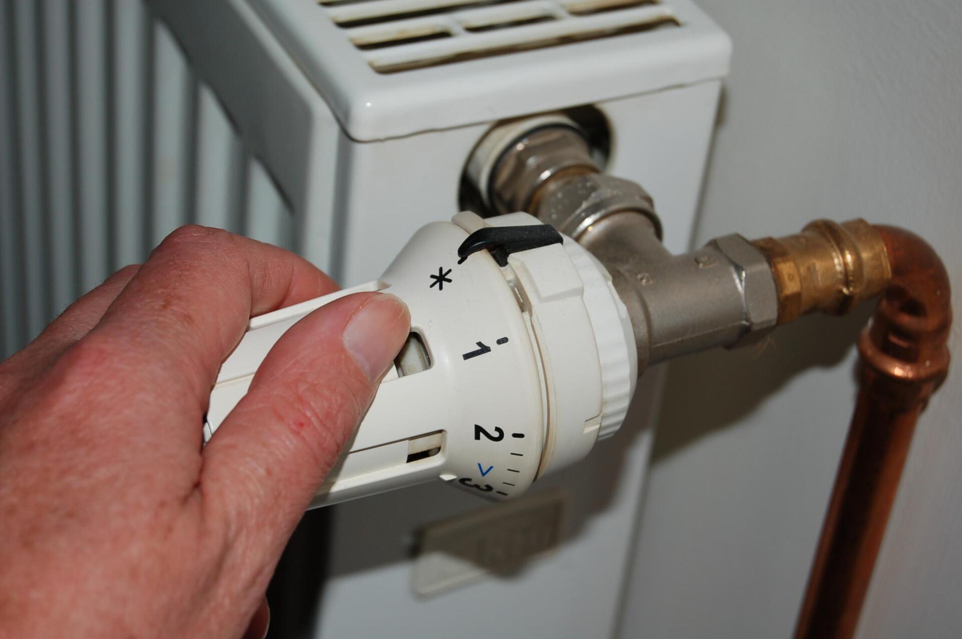 worker adjusting the air conditioner