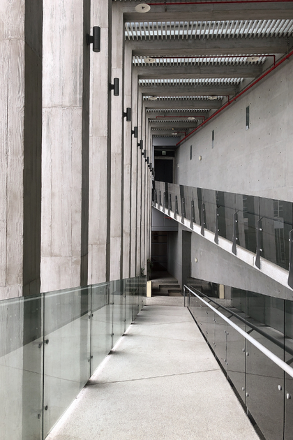 A long hallway in a building with a glass railing