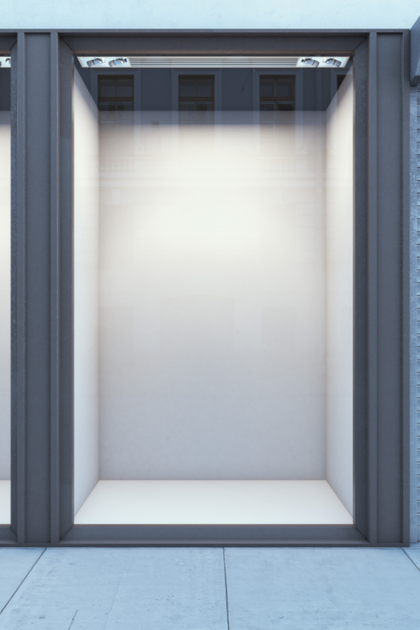 A row of empty store fronts with a gray frame