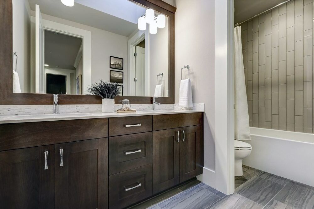 A Bathroom With Two Sinks , a Toilet , and a Bathtub — Kincumber Glass & Glazing in Kincumber, NSW