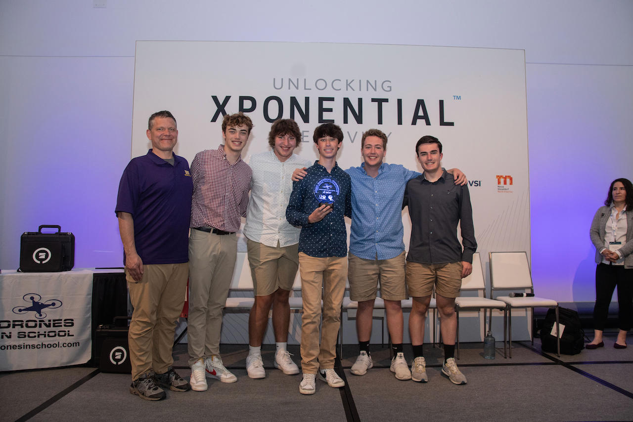 A group of young men are posing for a picture on a stage.