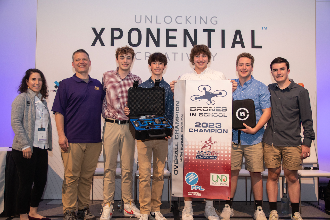 A group of young men are standing next to each other on a stage.