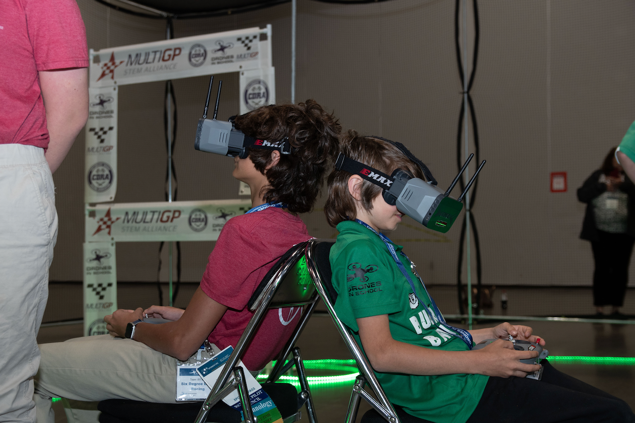 A man and a boy wearing virtual reality goggles