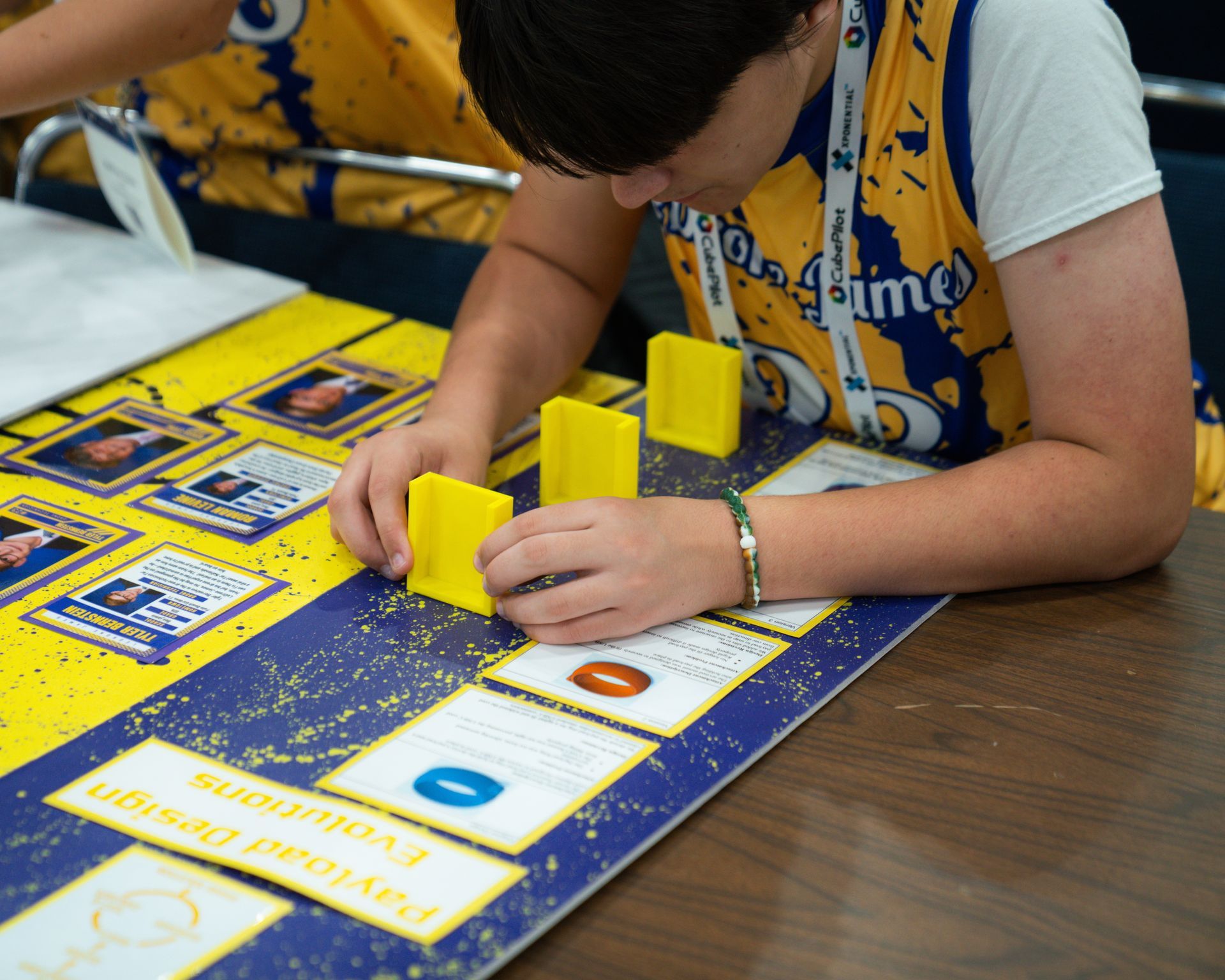A person wearing a yellow shirt with the word time on it