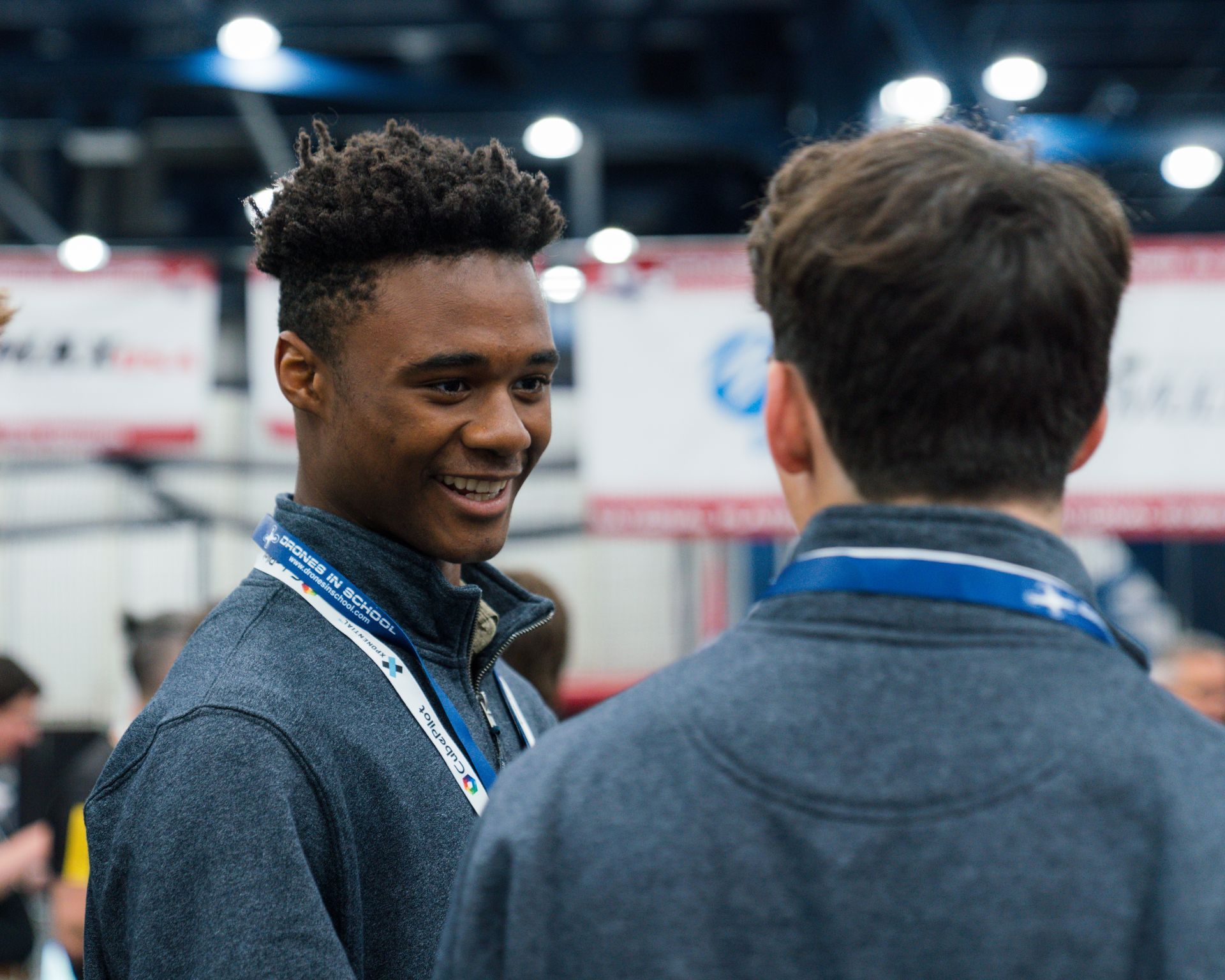 Two men are talking to each other and one of them is smiling