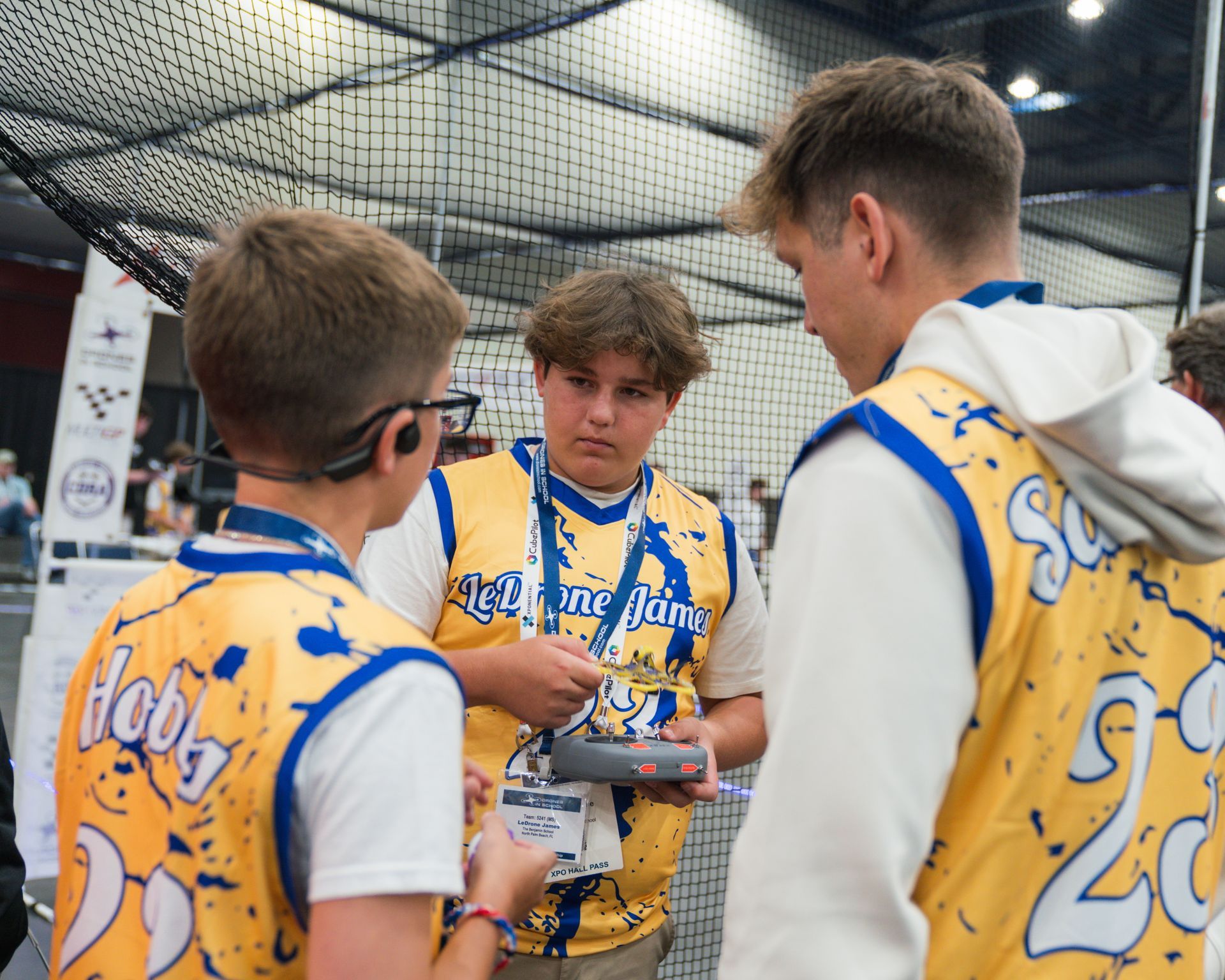 Three boys wearing yellow jerseys with the number 20 on them