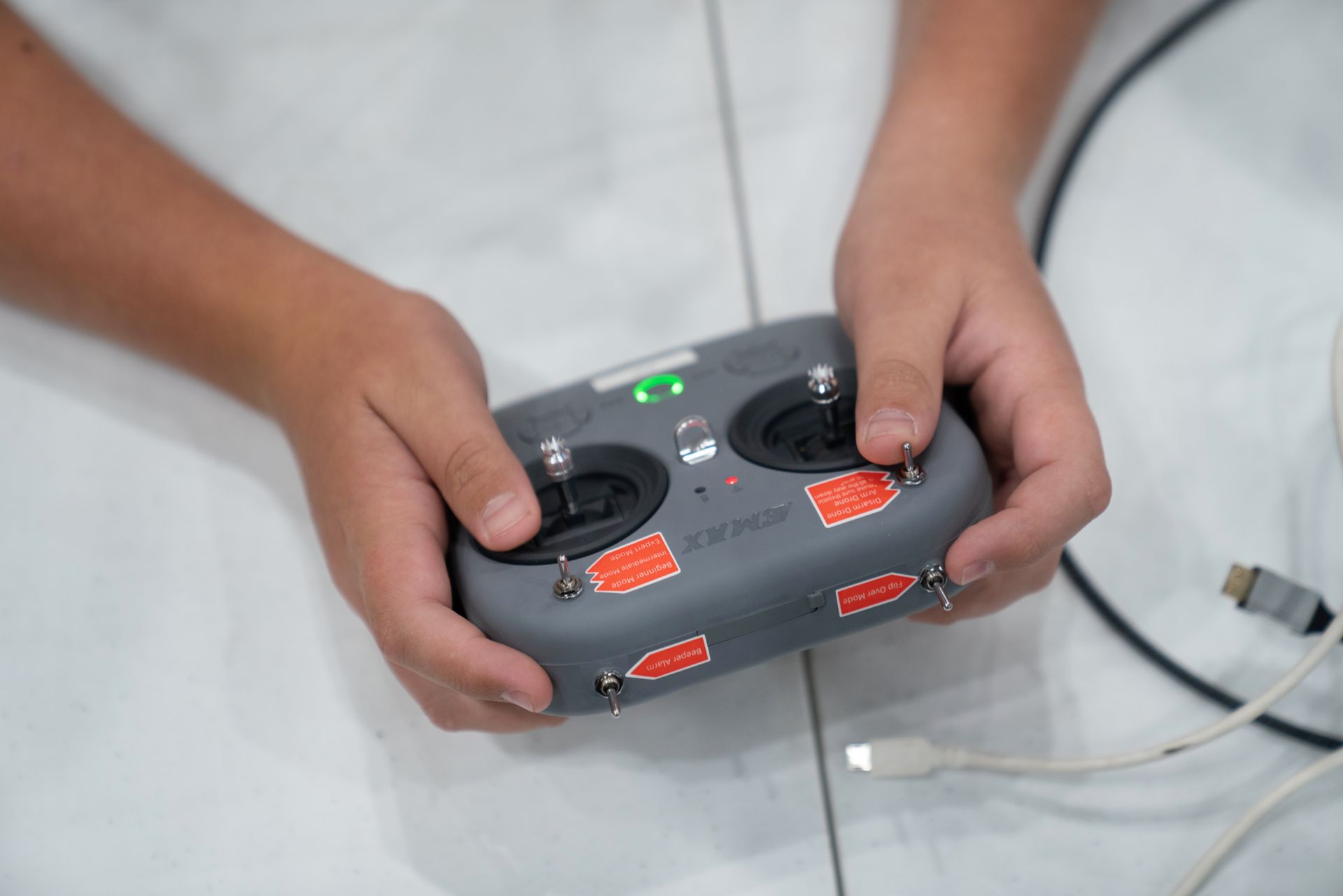 A person is holding a remote control in their hands.