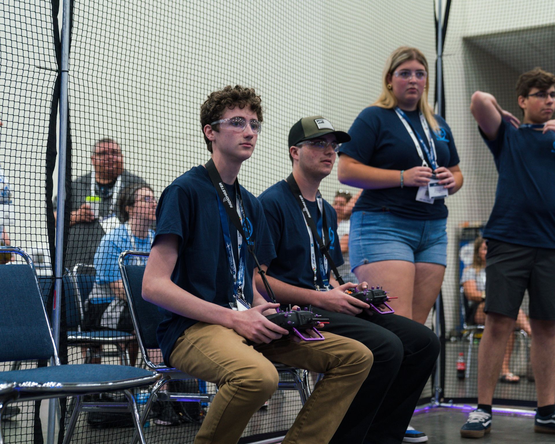 A group of people are sitting in chairs holding remote controls.