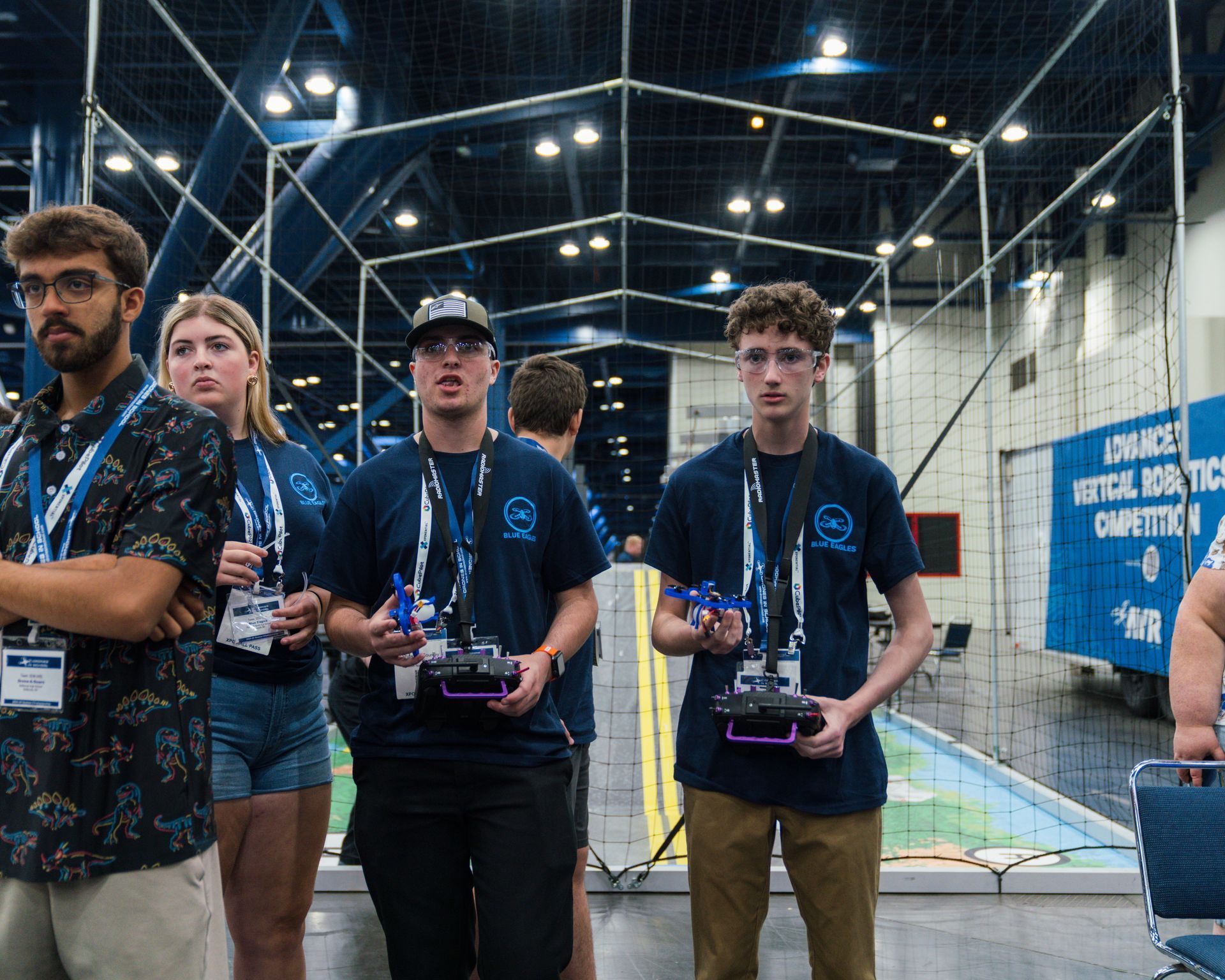 A group of people are standing in a room holding remote controls.
