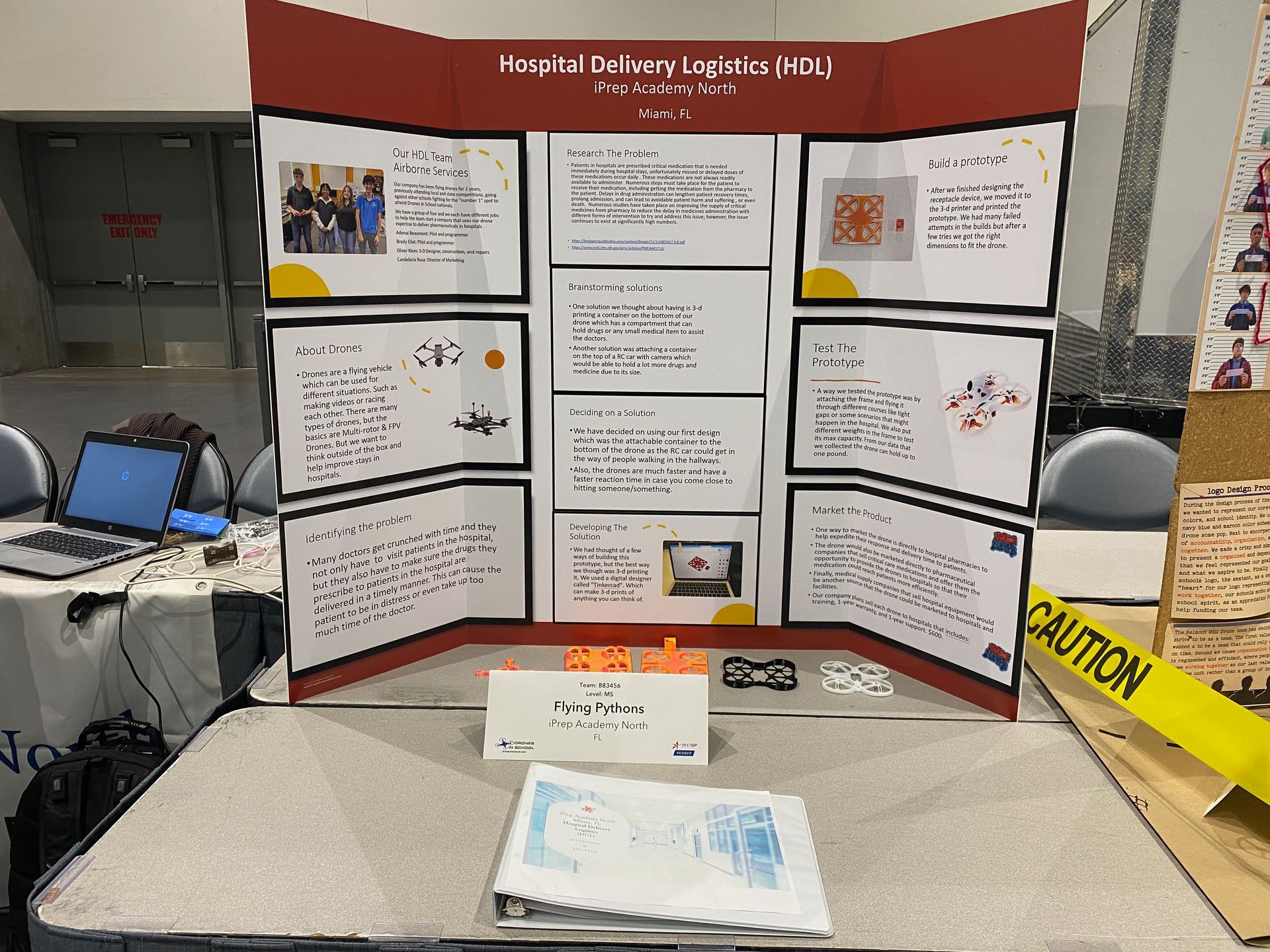 A table with a presentation board and a caution tape on it