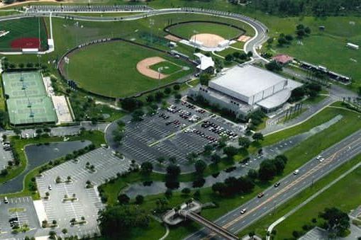 An aerial view of a baseball field and tennis courts