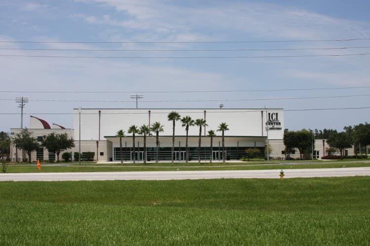 A large white building with palm trees in front of it