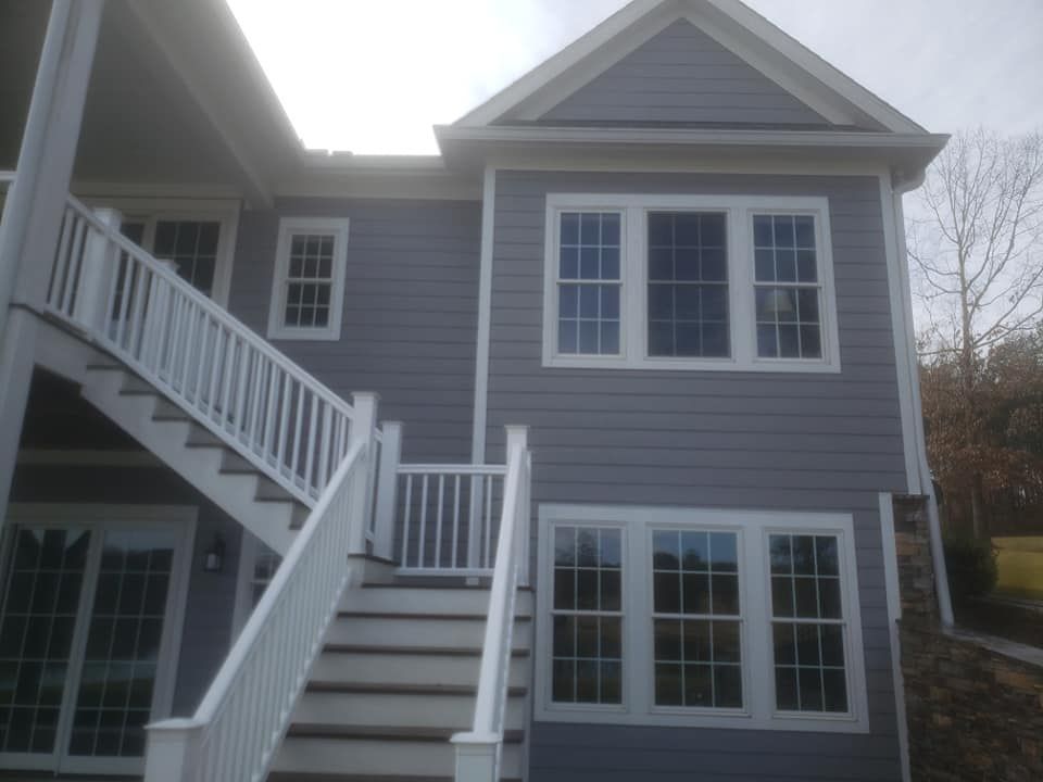 The back of a house with stairs leading up to it.