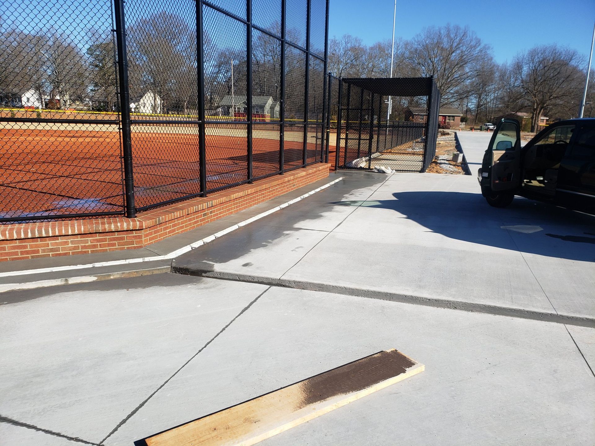 A truck is parked in front of a chain link fence