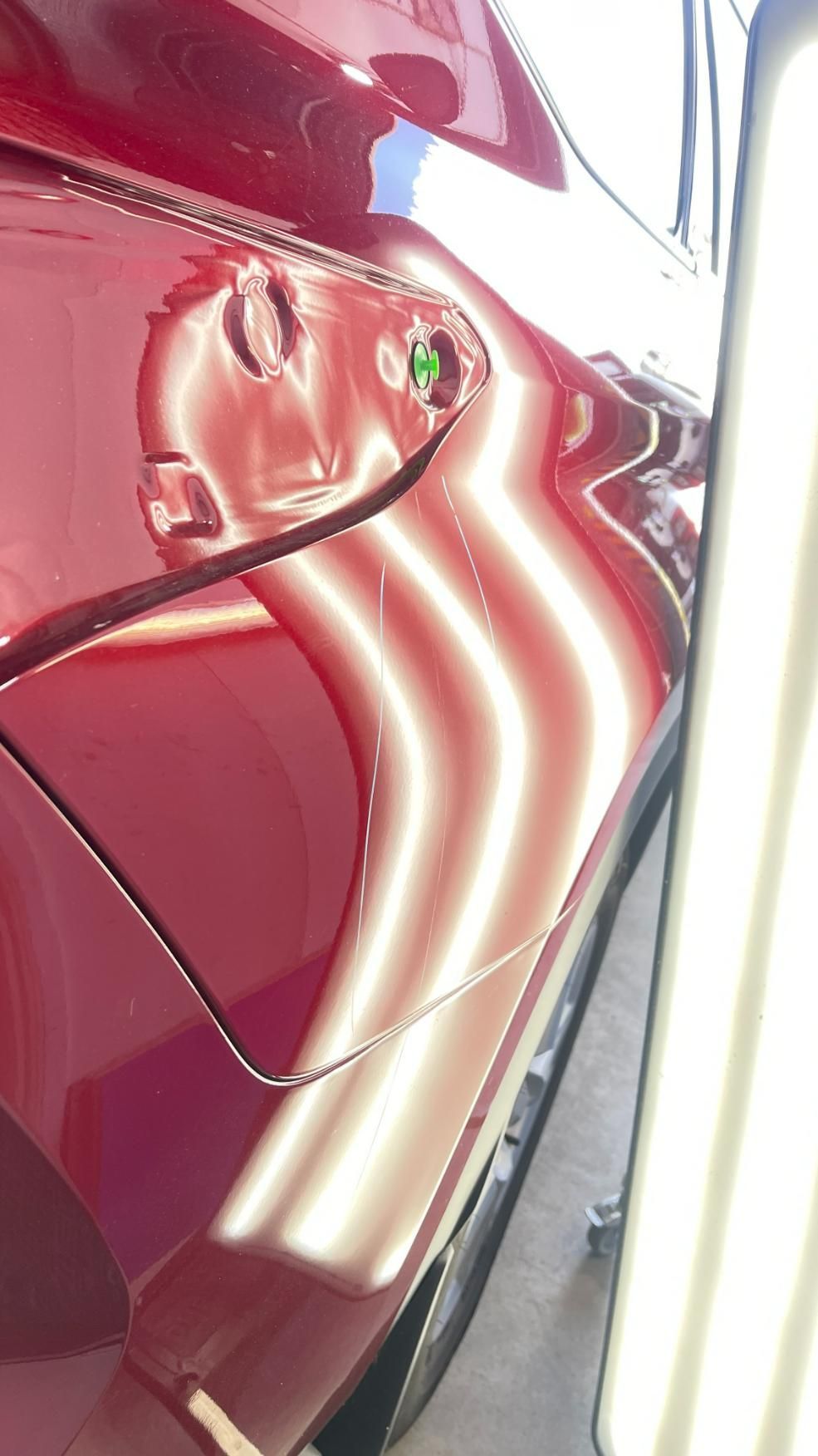 A Close up Of a Red Car with Dents on It — Dent Repair Specialist in Maroochydore, QLD