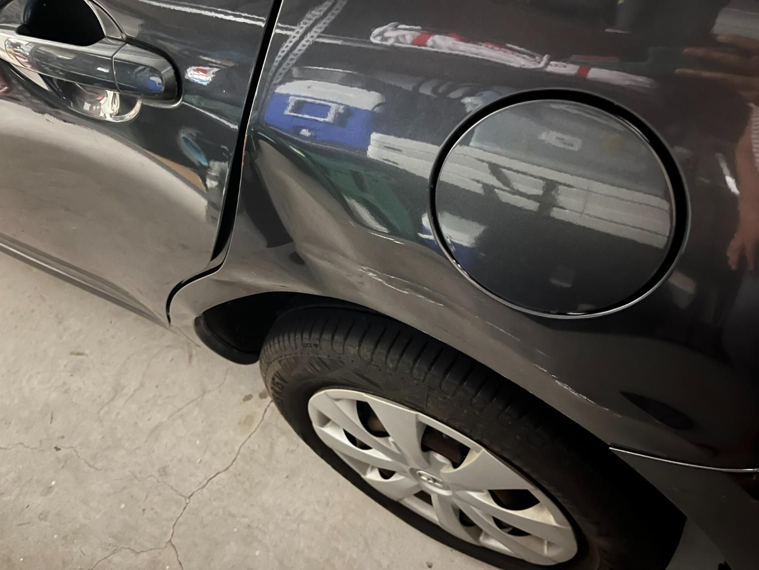 A Black Dented Car with A Round Gas Cap on The Side — Dent Repair Specialist in Maroochydore, QLD