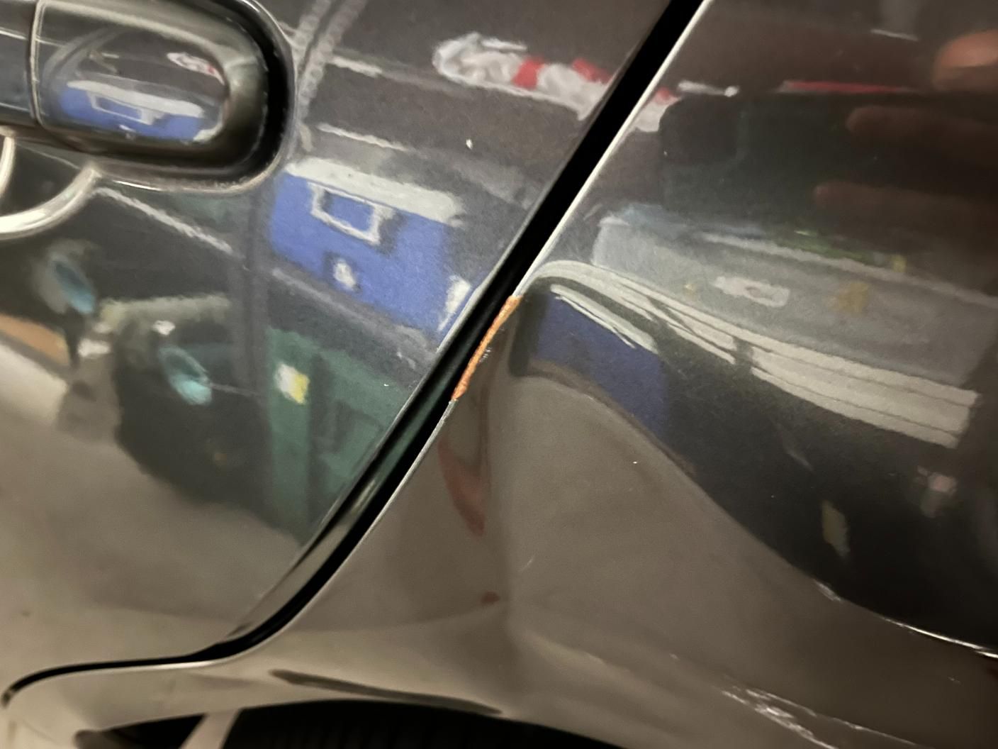 A Dented Car Is Parked in A Garage — Dent Repair Specialist in Caboolture, QLD
