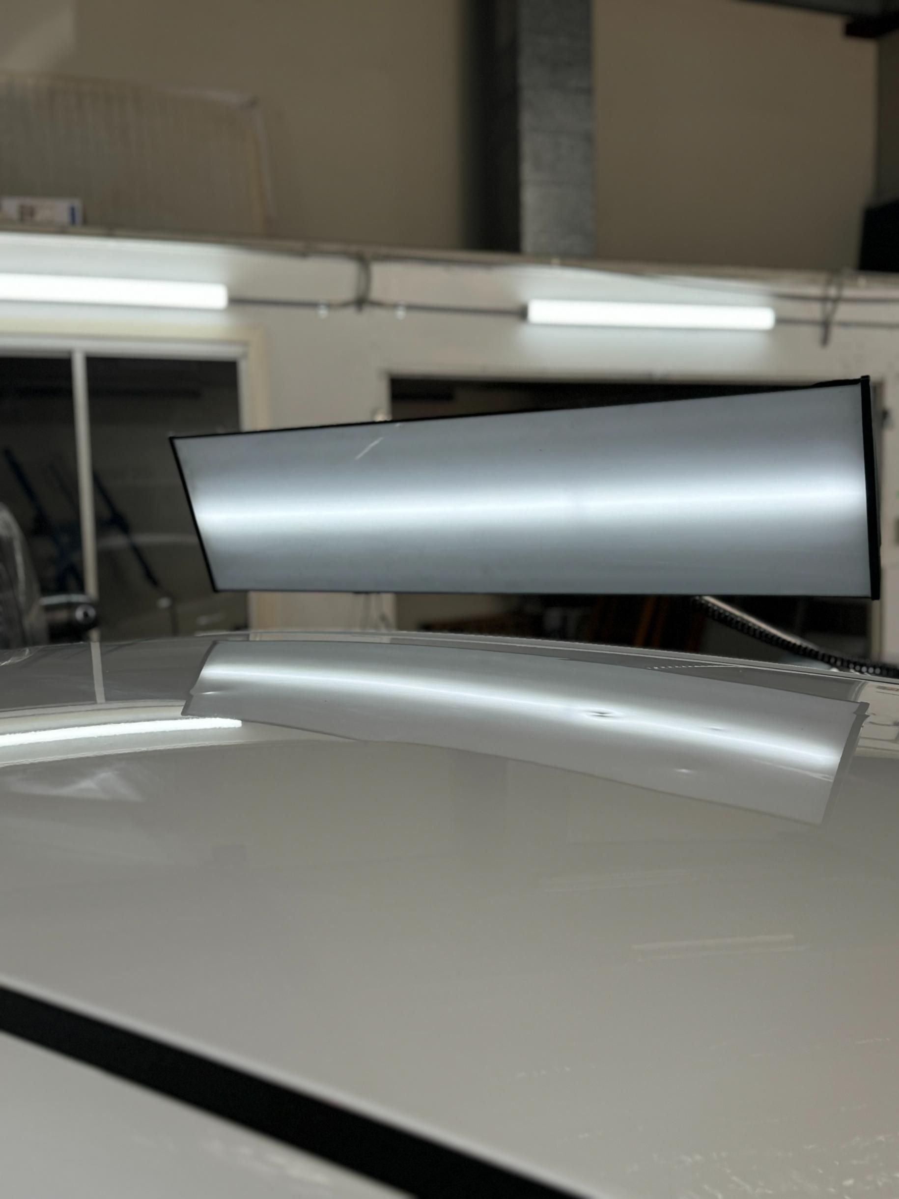 The Roof of A Car Is Being Repaired in A Garage — Dent Repair Specialist in Caboolture, QLD
