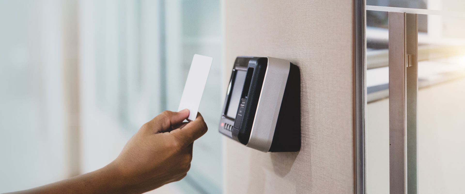 A person is using a key card to open a door.