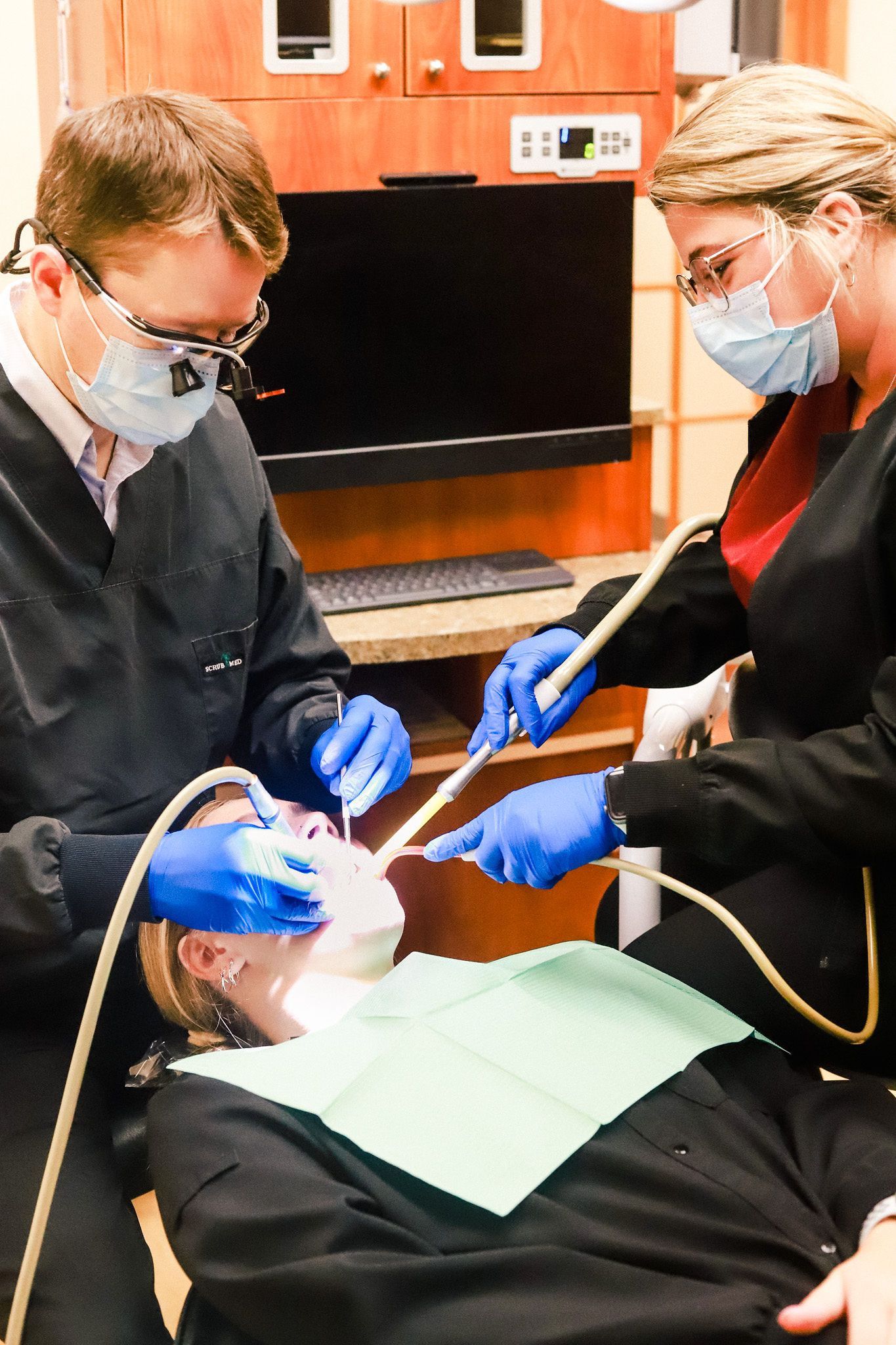 Dentist explaining a dental implant model to a patient