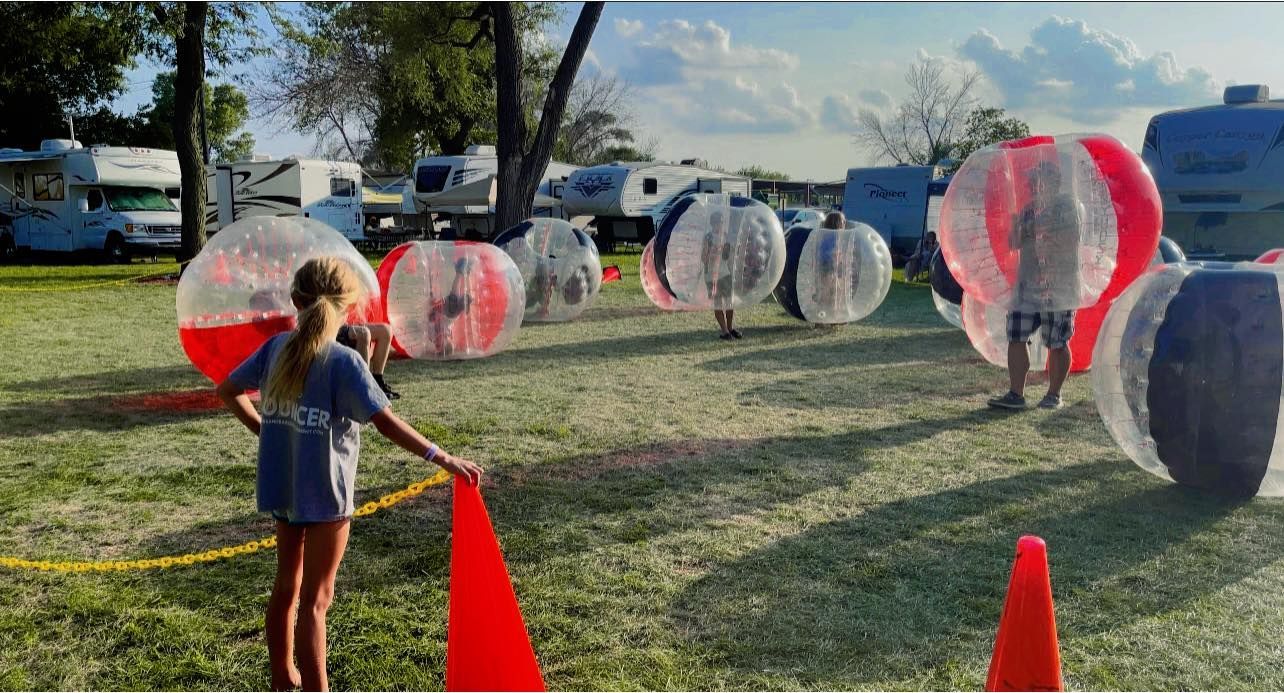 A group of people playing with inflatable knocker balls.