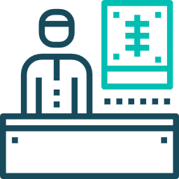 A dark teal outline icon of a person at a desk reviewing a teal X-ray or medical chart displayed on a screen.