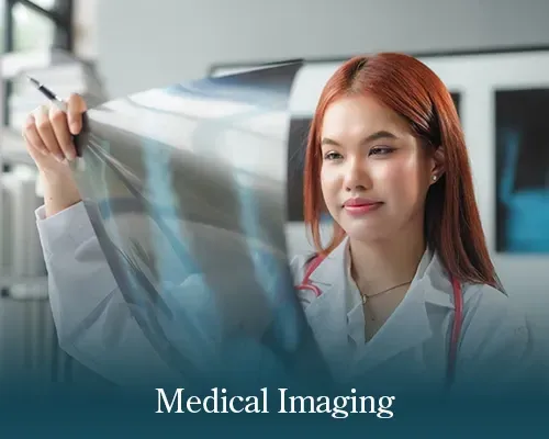 Woman holding an X-ray film in a medical imaging setting