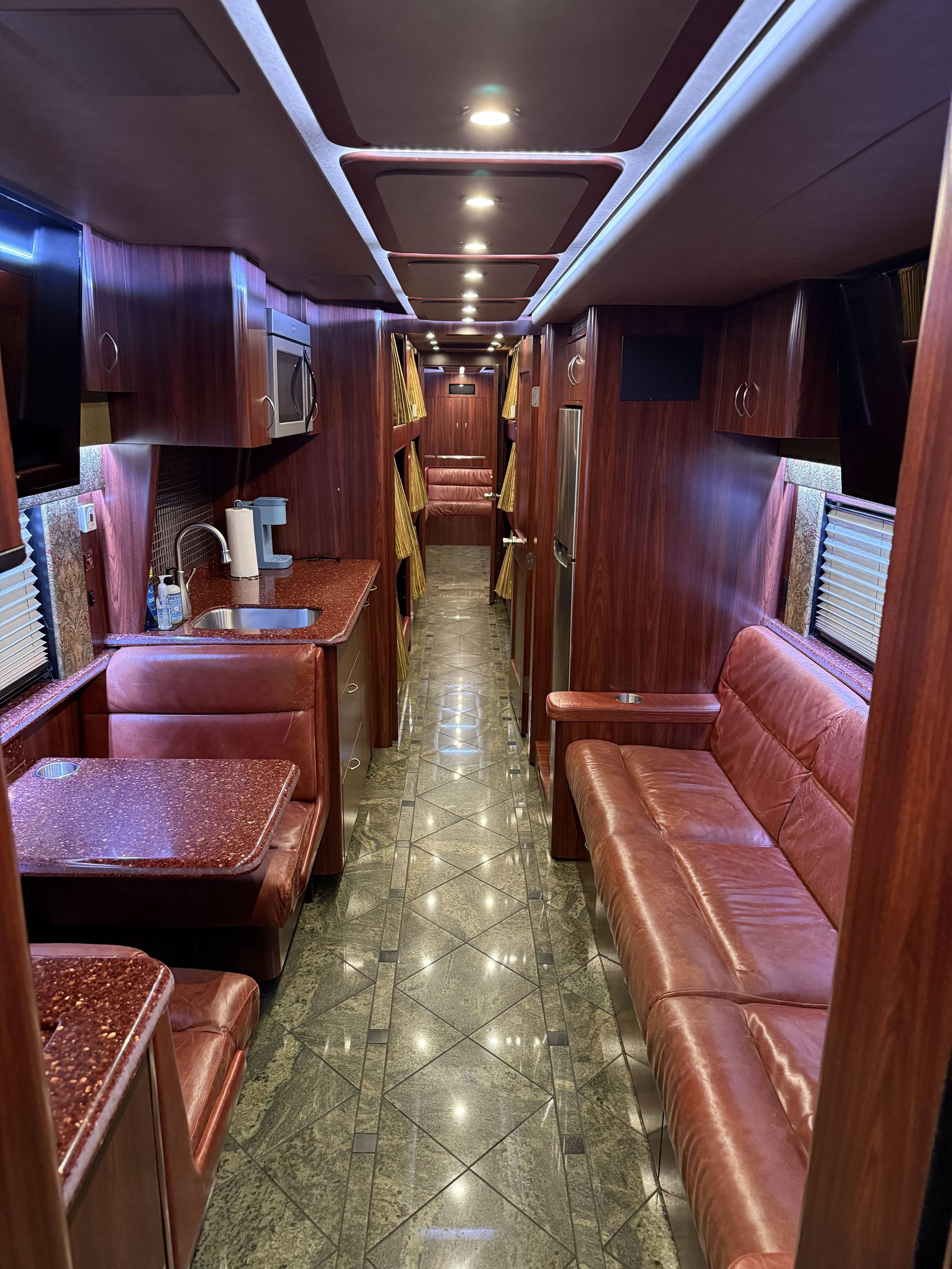 Kitchen area with microwave, refrigerator, and coffee maker inside Coach 14
