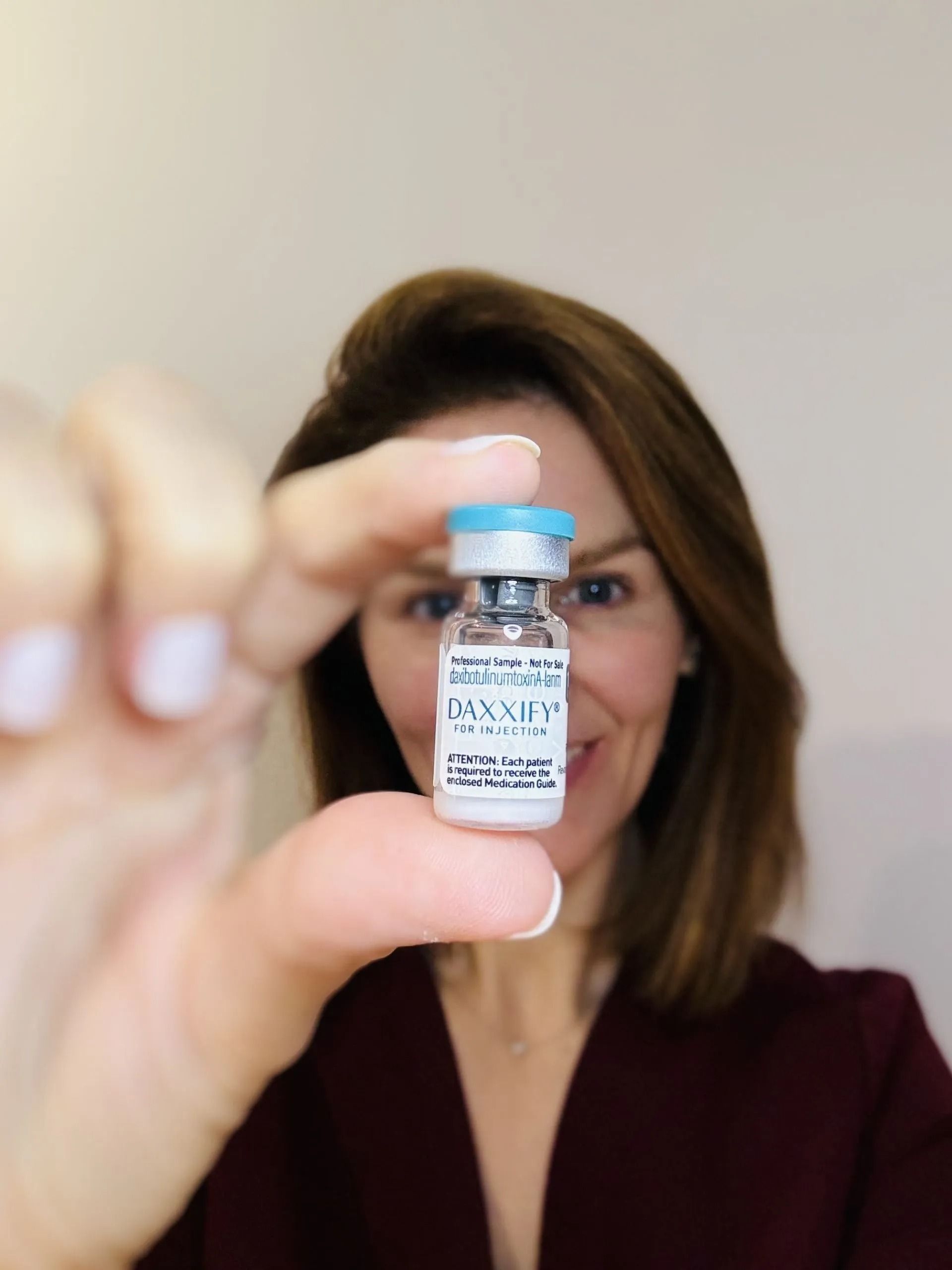 Tanya Cook-Riley holding a vial of Daxxify at Good Skin Aesthetics in Loomis, California