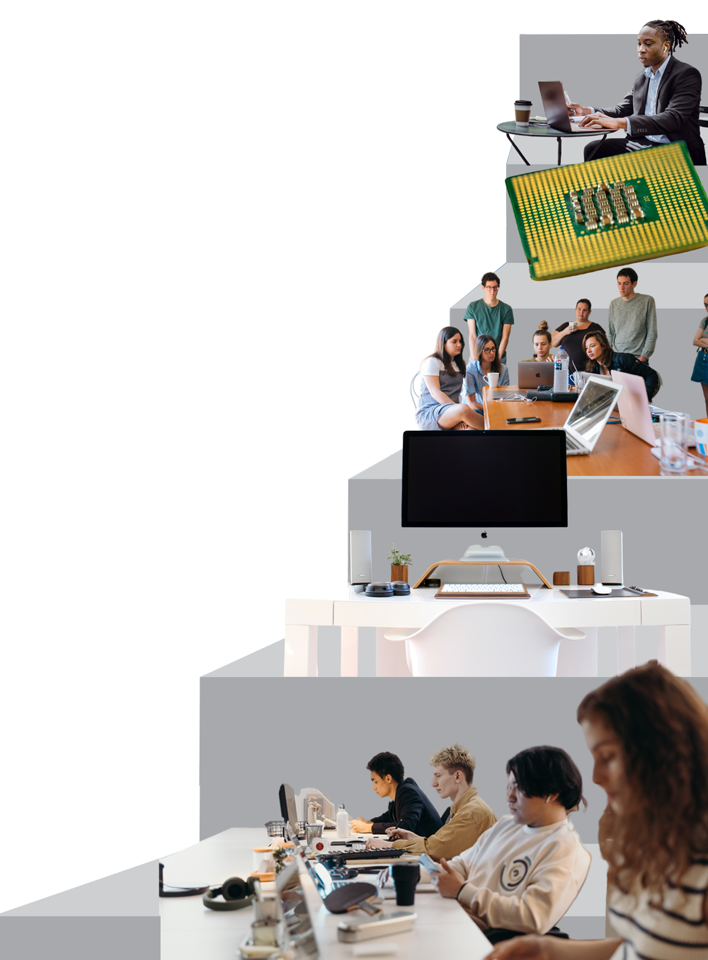 A group of people are sitting at desks in an office.