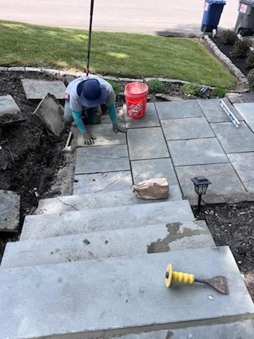 Man Laying Tiles On A Set Of Stairs — Hudson Valley — G & R Masonry