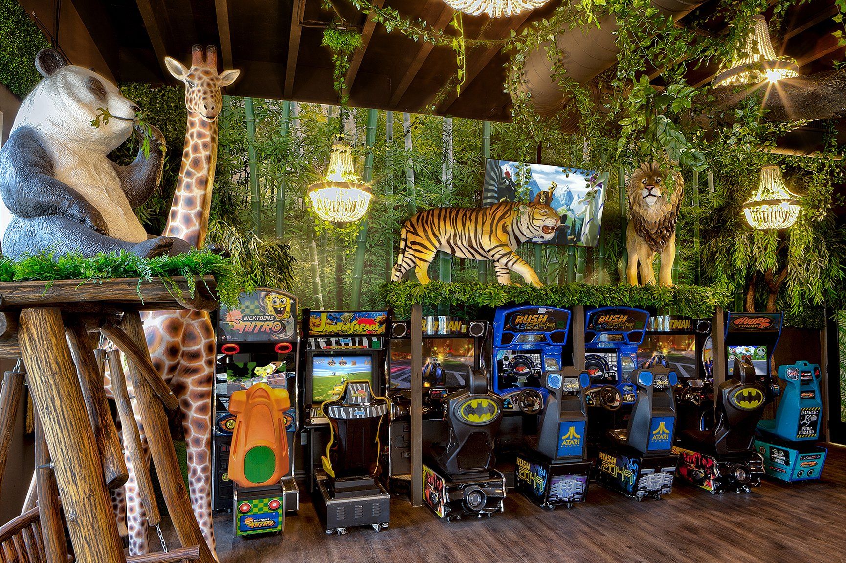 Tropical jungle-themed arcade with rows of colorful game machines and hanging lanterns