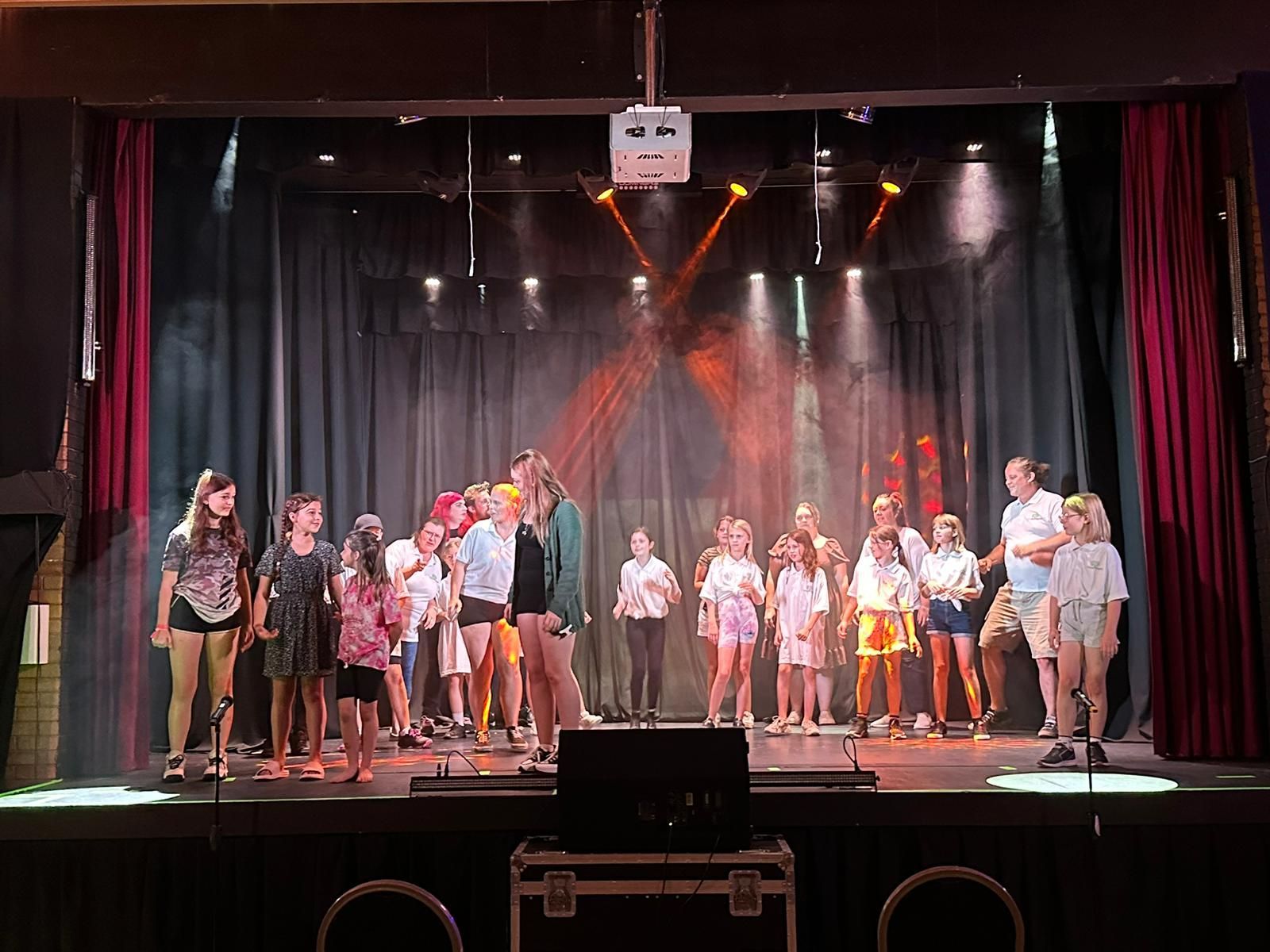 A group of young people are standing on a stage.