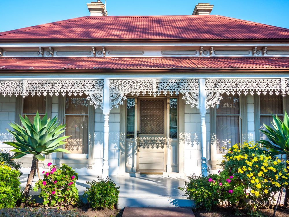 Victorian House Porch With Ornate White Trim, and Red Roof — Andrew Harper Painting & Decorating in Albury, NSW