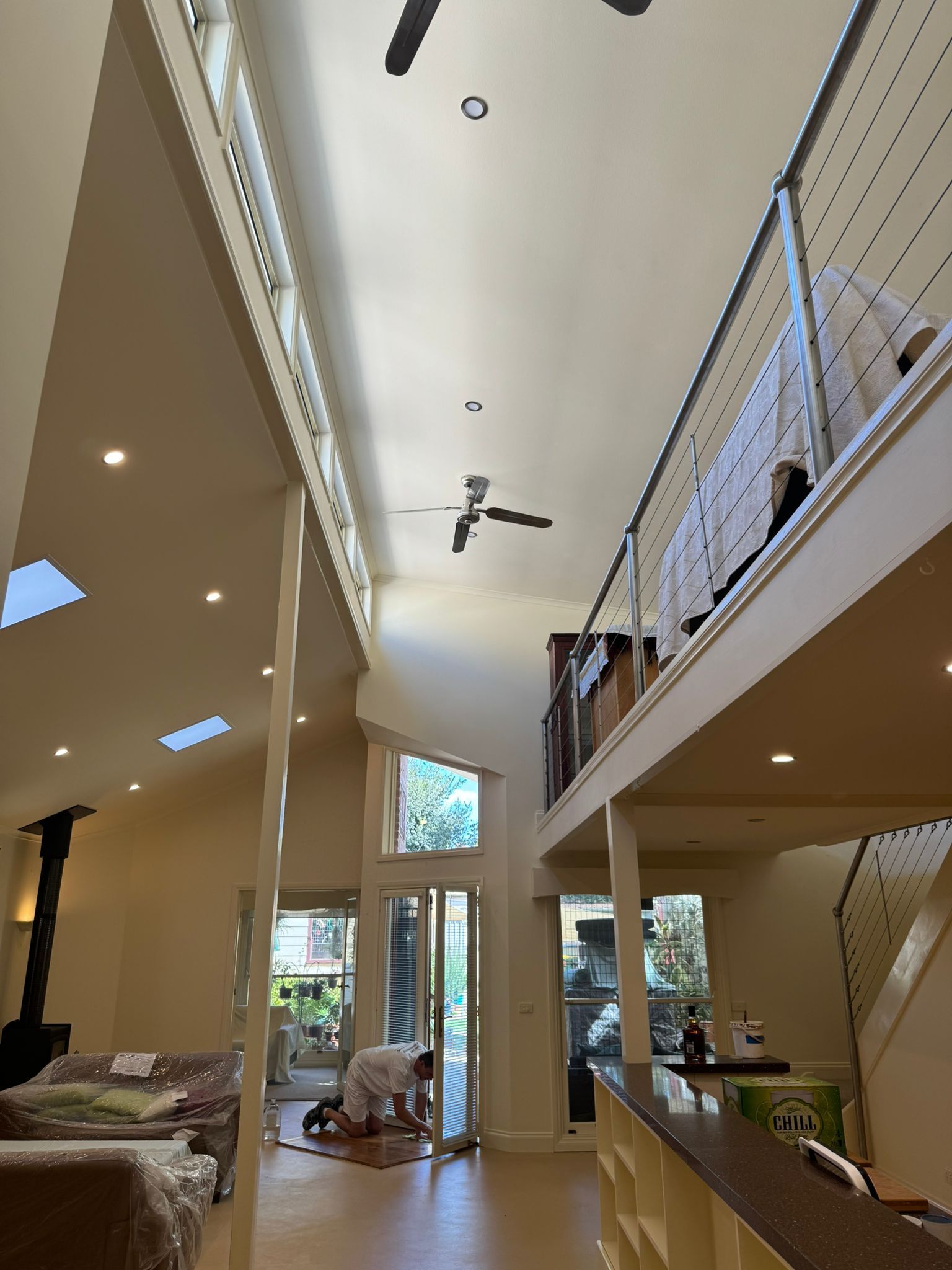 Empty Room With Blue Walls, White Trim and Doors, and  Wood Floor — Andrew Harper Painting & Decorating in Albury, NSW