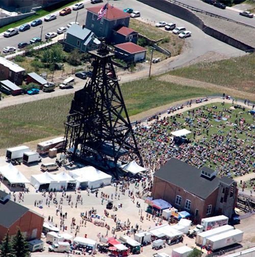 An aerial view of a large crowd of people gathered around a large structure