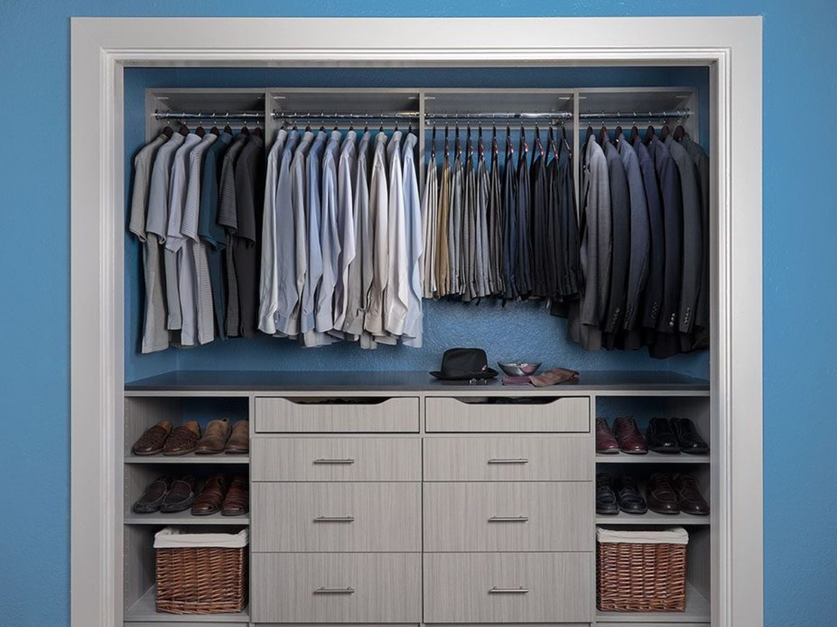 A closet filled with lots of clothes and shoes.