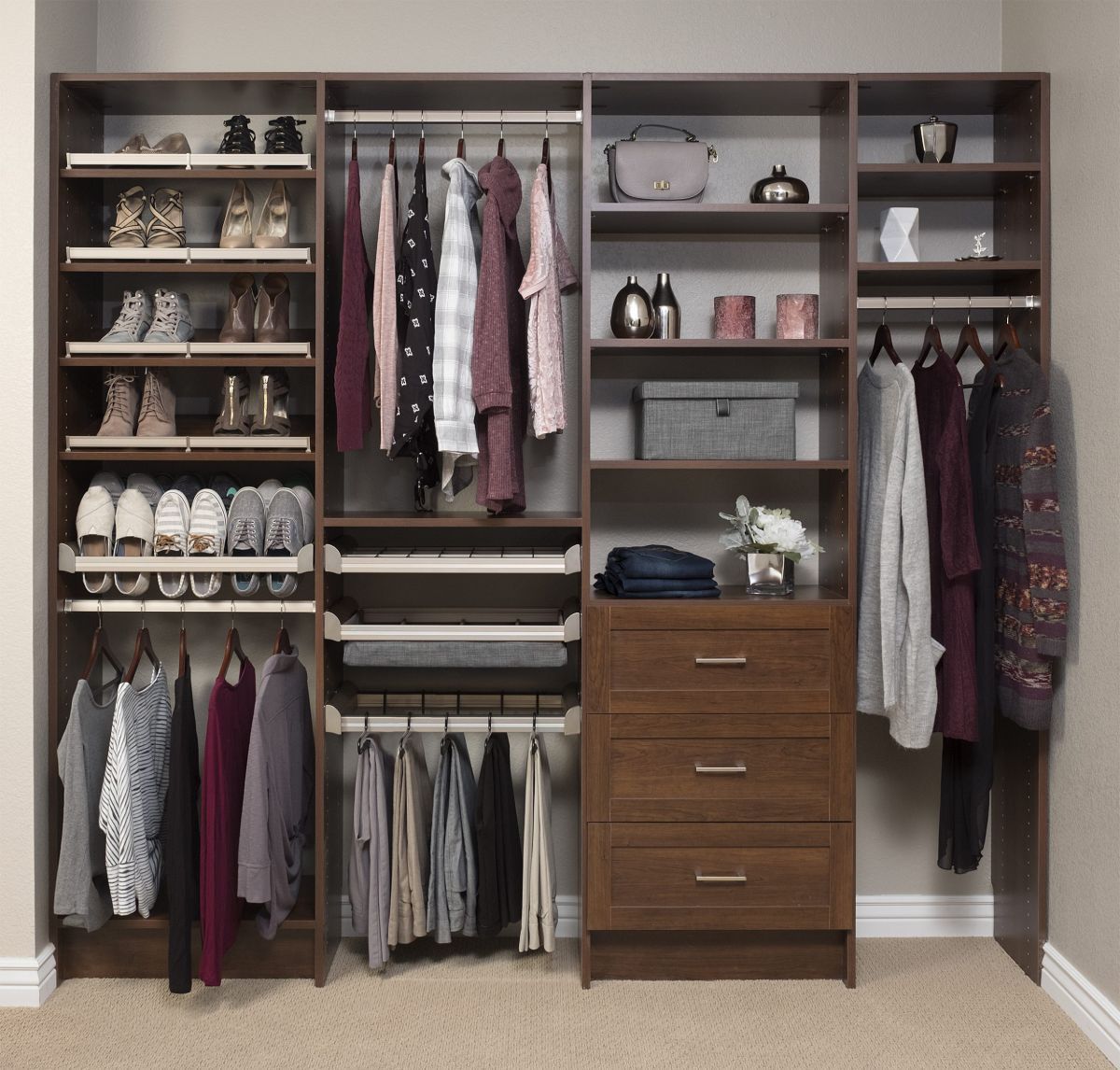 A closet with lots of clothes and shoes on shelves