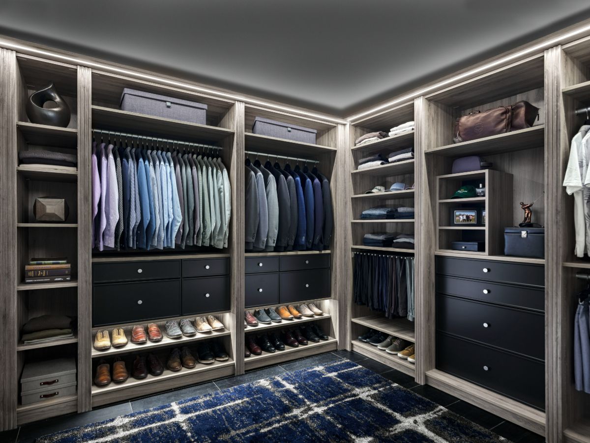 A walk in closet filled with lots of clothes and shoes