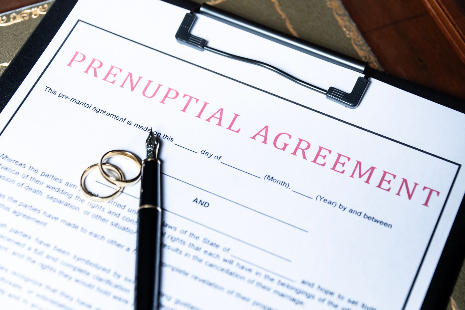 A clipboard with the word prenuptial agreement on it